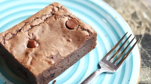 Delicious Brownie on a Blue Plate with Fork