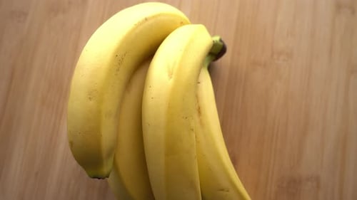 Bunch of Yellow Bananas Close Up on Wood