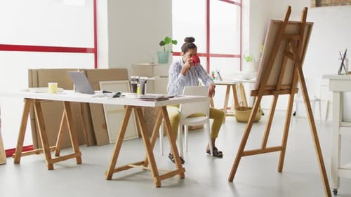 Video einer glücklichen Designerin aus Biracial, die Kaffee im Studio trinkt