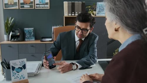 Indian Bank Employee Answering Questions of Elderly Woman About Smartphone App