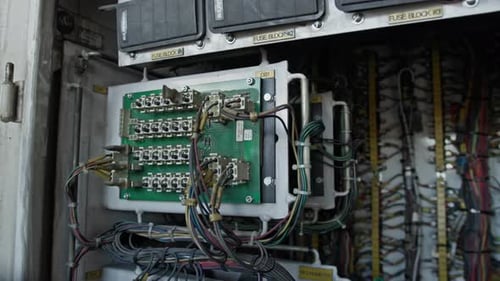 Close-up of industrial control panel with circuit boards and wiring used for telecommunications and