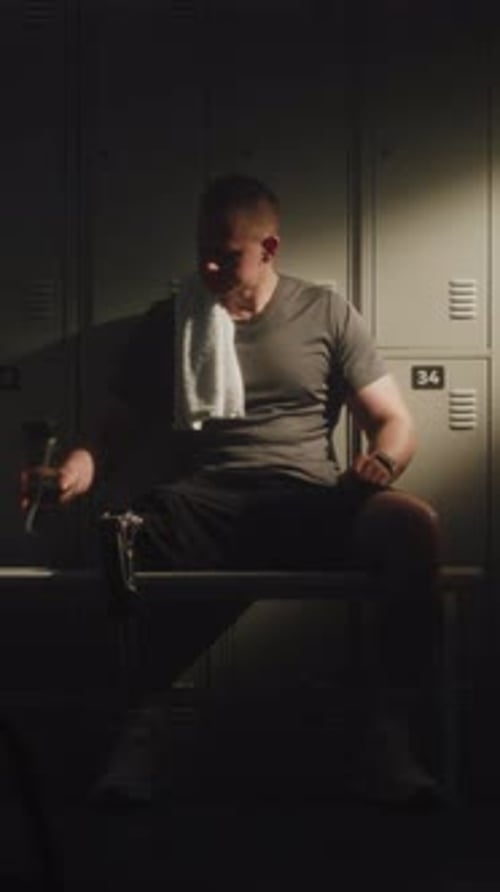 Professional Athlete with Leg Prosthesis Resting in Dressing Room