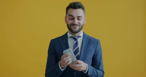 Slow Motion Portrait of Successful Entrepreneur Holding Money Then Throwing Banknotes and Smiling
