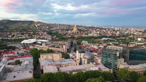 Aerial: Tbilisi at sunset with The Holy Trinity Cathedral in background, Georgia