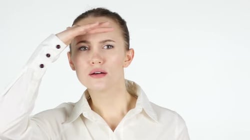 Woman Shields Eyes While Looking for Something Indoors