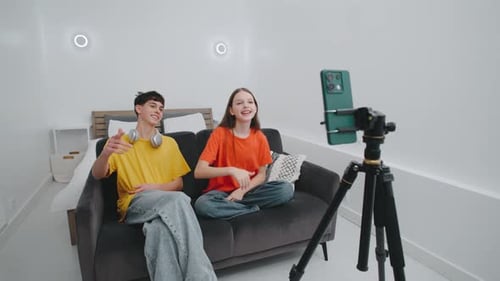 Two Young Adults Vlogging in their Bedroom