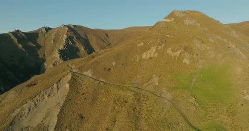 Mountain hike path on Isthmus Peak in Southern Alps landscape of New Zealand, golden hour
