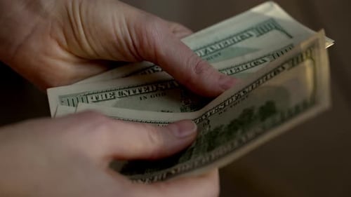 Handling Cash Transaction With Hundred Dollar Bills in Close-Up View