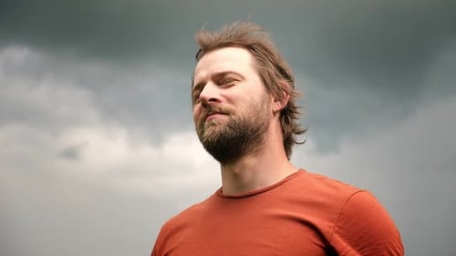 Man Enjoying the Breeze on a Windy Day