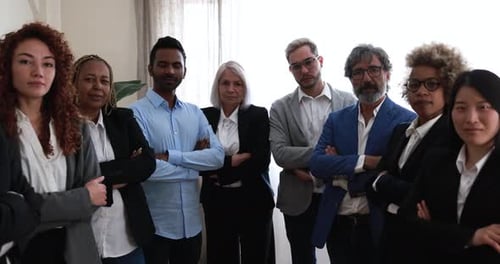Multiracial Business People Looking At Camera Inside Modern Office