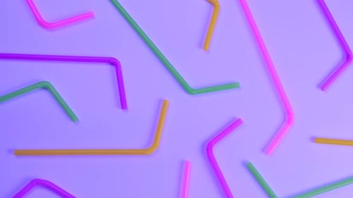 Rotating Multicolored Cocktail Straws on a Purple Background Top View the Concept of Celebrating a