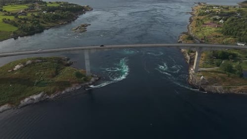A Bridge Spans Powerful Swirling Currents as Tidal Waters Rush Through the Narrow Strait at