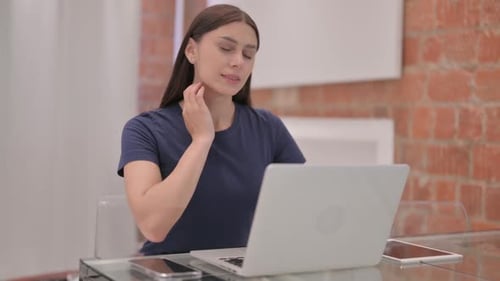 Woman Types on Laptop Then Massages Neck
