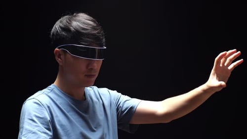 Close Up Side View Of Asian Man Touch And Swipe Virtual Reality While Using Futuristic Goggles