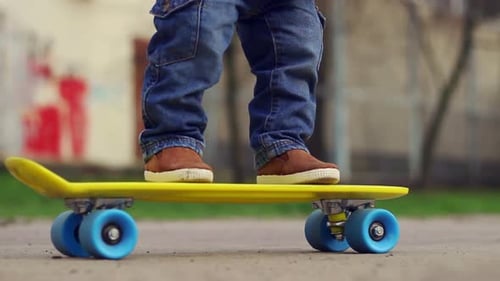 Child's Feet on Skateboard in Urban Environment