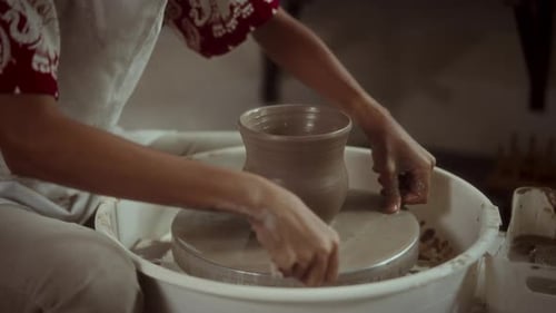 Potter Shapes Clay Pot on Pottery Wheel
