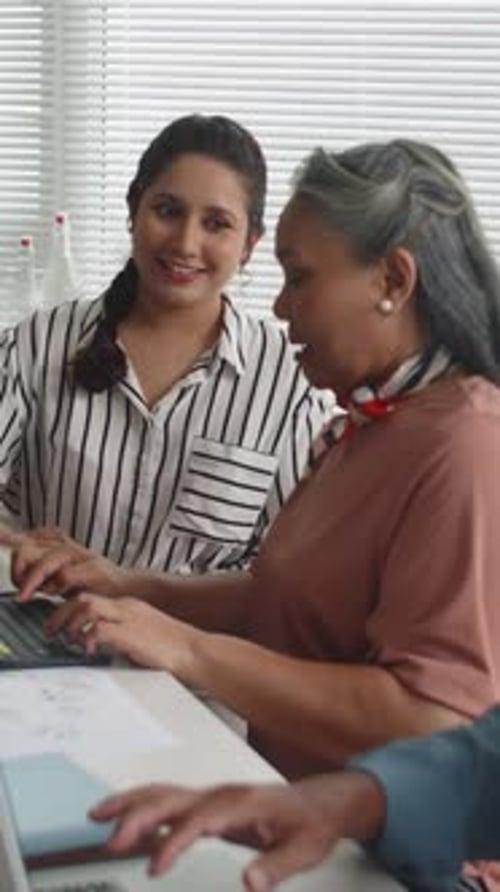 Women Collaborating in Office at Desk