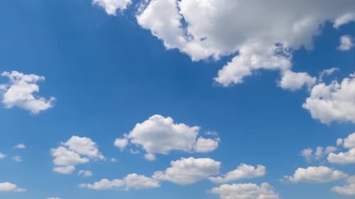 Soft beautiful clouds forming in the blue sky. Clouds flying quickly in the rays of sun. Timelapse.