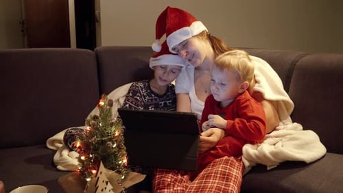 Family Watching Tablet Together at Christmas Time