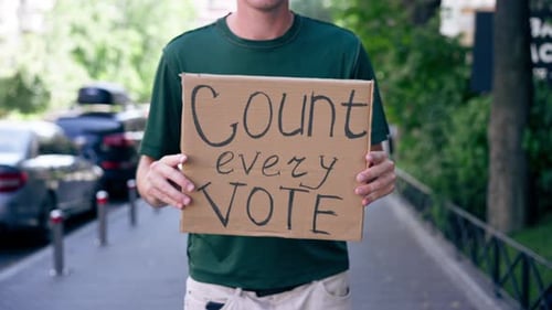 Close Up Protester Guy with Sign in His Hands Presidential Elections Election Campaign Bribery