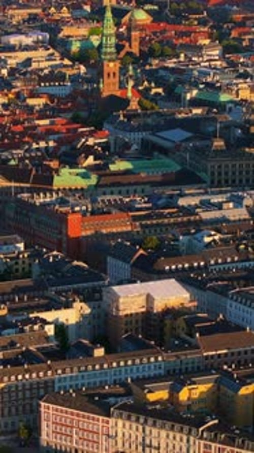 Aerial drone view of the city centre of Copenhagen, Denmark at sunset. Vertical