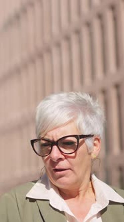 Businesswomen Walking and Talking Outside Office Building