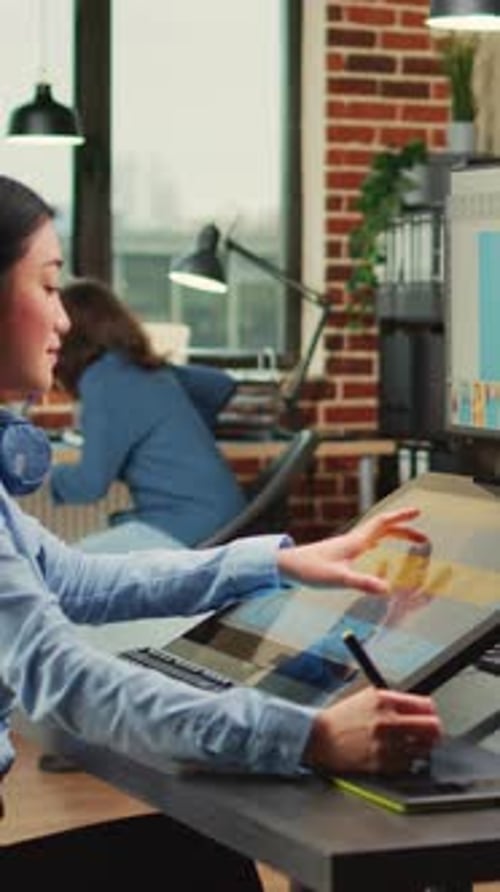 Woman Using Graphics Tablet in an Office