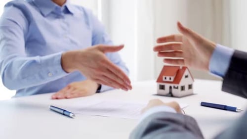 Business, Real Estate, Deal And People Concept - Man Giving House Keys To Woman And Shaking Hands...