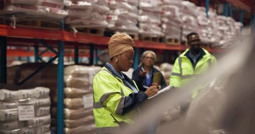 Warehouse, group and women with clipboard, logistics and inventory for order process and discussion