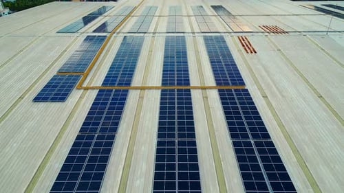 Aerial View of Solar Panels on Industrial Roof Drone Shot