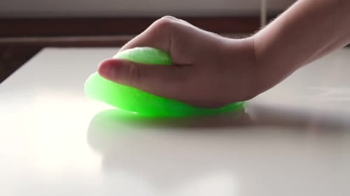 Hand Playing with Textured Slime with Bubbles Stretching the Gooey Substance Female Teen Hand