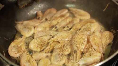 Frying Shrimps in a Pan with Oil and Spices in White Sauce