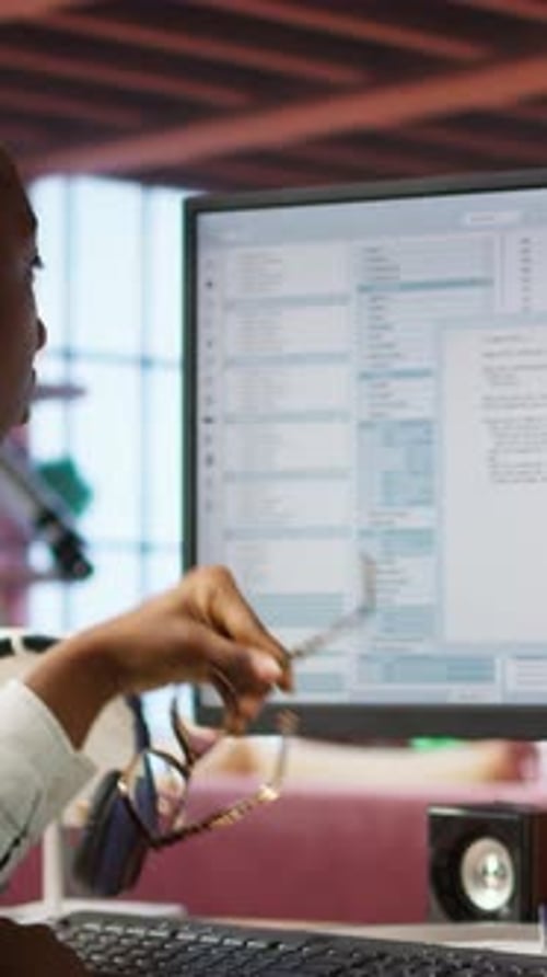 Woman Working at Computer in Office Is Tired