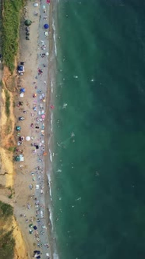 Aerial View of Sandy Beach Swimming People in Sea Bay with Transparent Blue Water at Sunset in