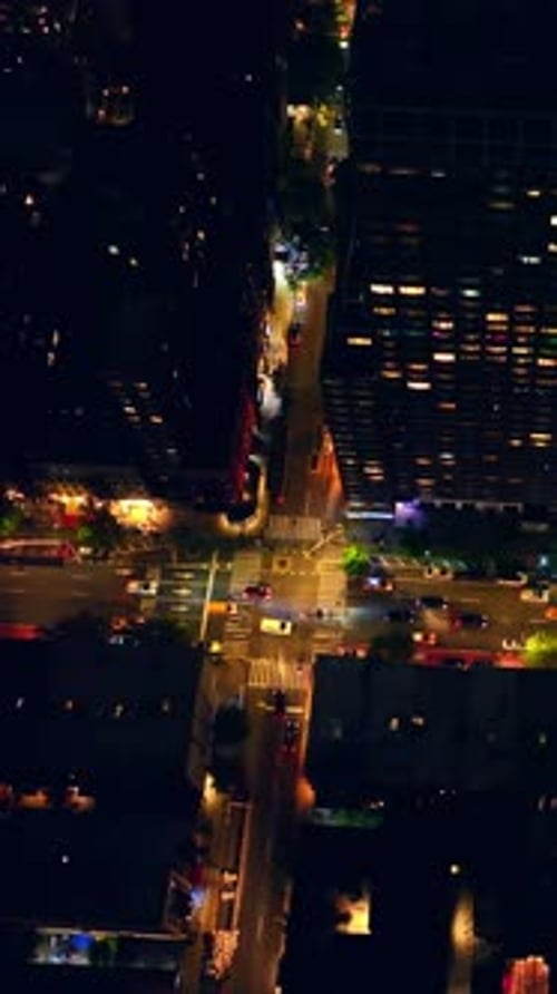 Cars crossing the numerous crossroads. Beautiful well-lit streets of New York at night.