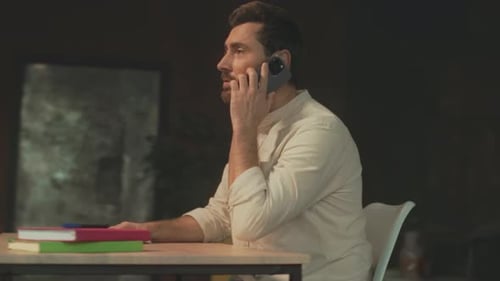 Man Talking on Phone While Sitting at Desk