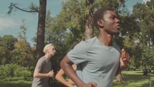Athletic Friends Jogging in Park Together