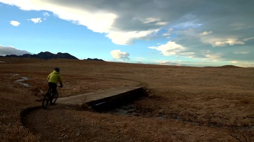 Slow motion footage of mountain biker riding in a mixed trail