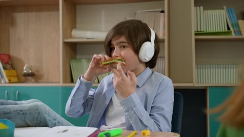 Elementary School Class Children Communicate with the Teacher Answering Question