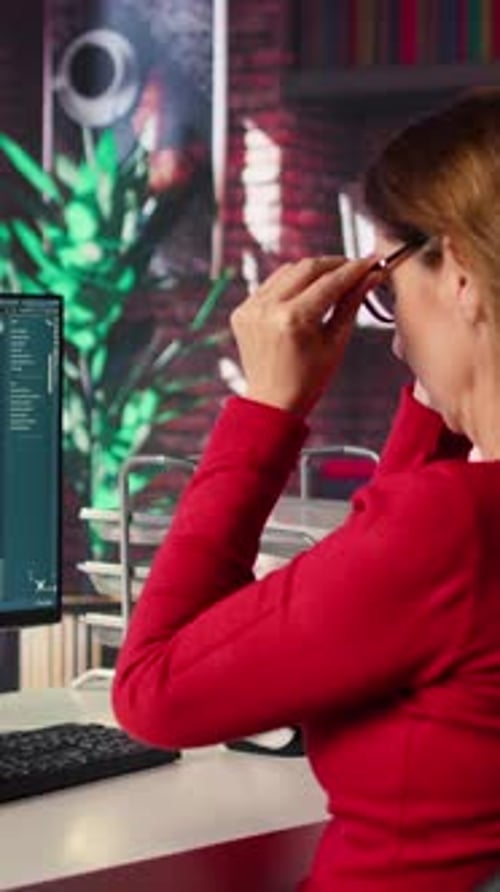 Woman Editing Images at Computer Workstation