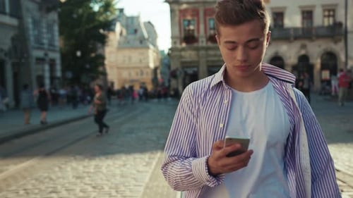 Portrait Young Serious Man Walk on Street Use Phone Look Around Sunlight Cute Work Mobile Gadget