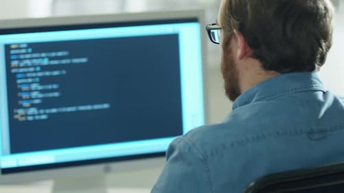 Programmer Coding at Computer Station