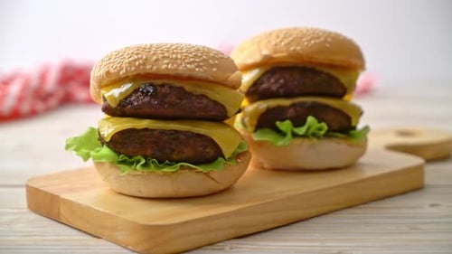 Two Double Cheeseburgers on a Wooden Cutting Board
