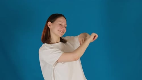Woman stretching arms on blue background