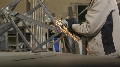 Man in Workwear Welding at Factory