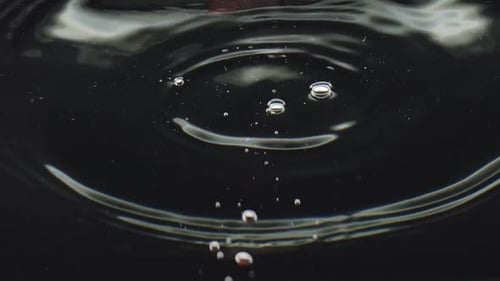 Strawberries Falling Into Water With Bubbles