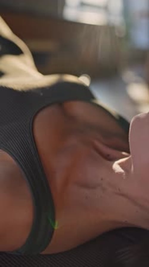 Woman in Athletic Wear Breathing Correctly During Exercise Glute Bridge Determination and Strength