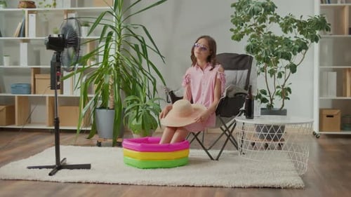 Sad Young Woman in Sunglasses Resting at Home and Dreaming About Vacation