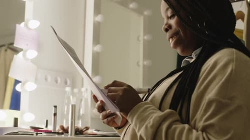 Woman Designer Writing Notes in Dressing Room