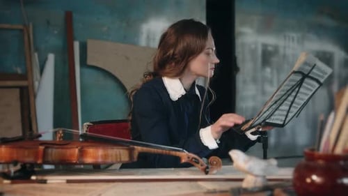 Woman Reading Music From Sheet on Stand